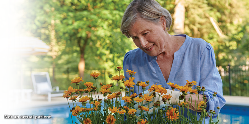 Woman tending to flowers.