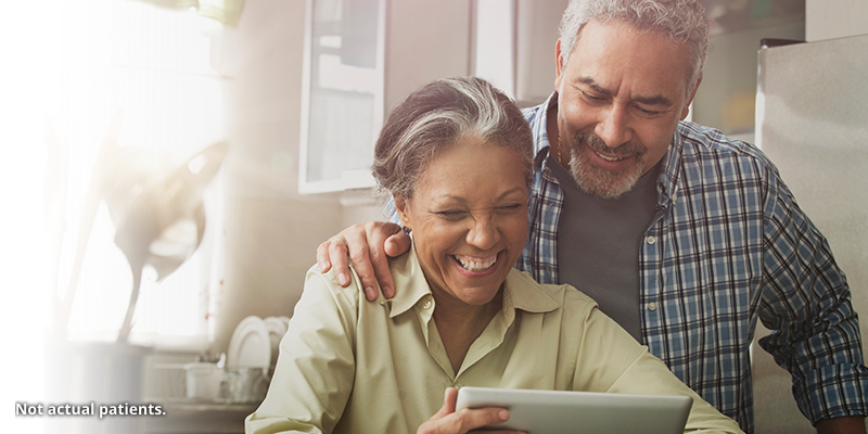 Man and woman looking at a tablet together.